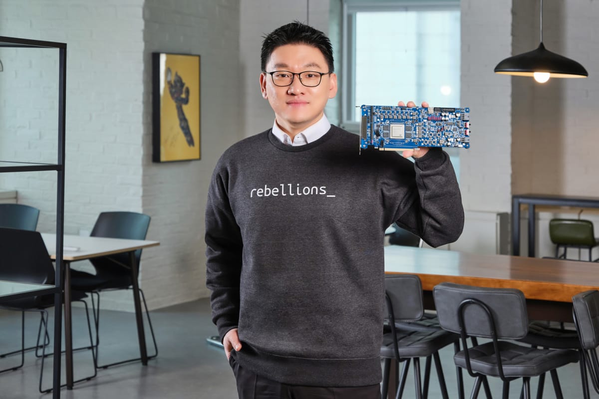 Park Sung-hyun, CEO of Rebellion, standing in an office holding his company's AI server card