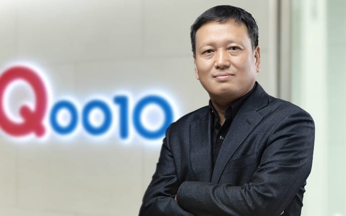 Ku Young Bae, CEO of Tmon and Wemakeprice parent company Qoo10 pictured in front of Qoo10 logo